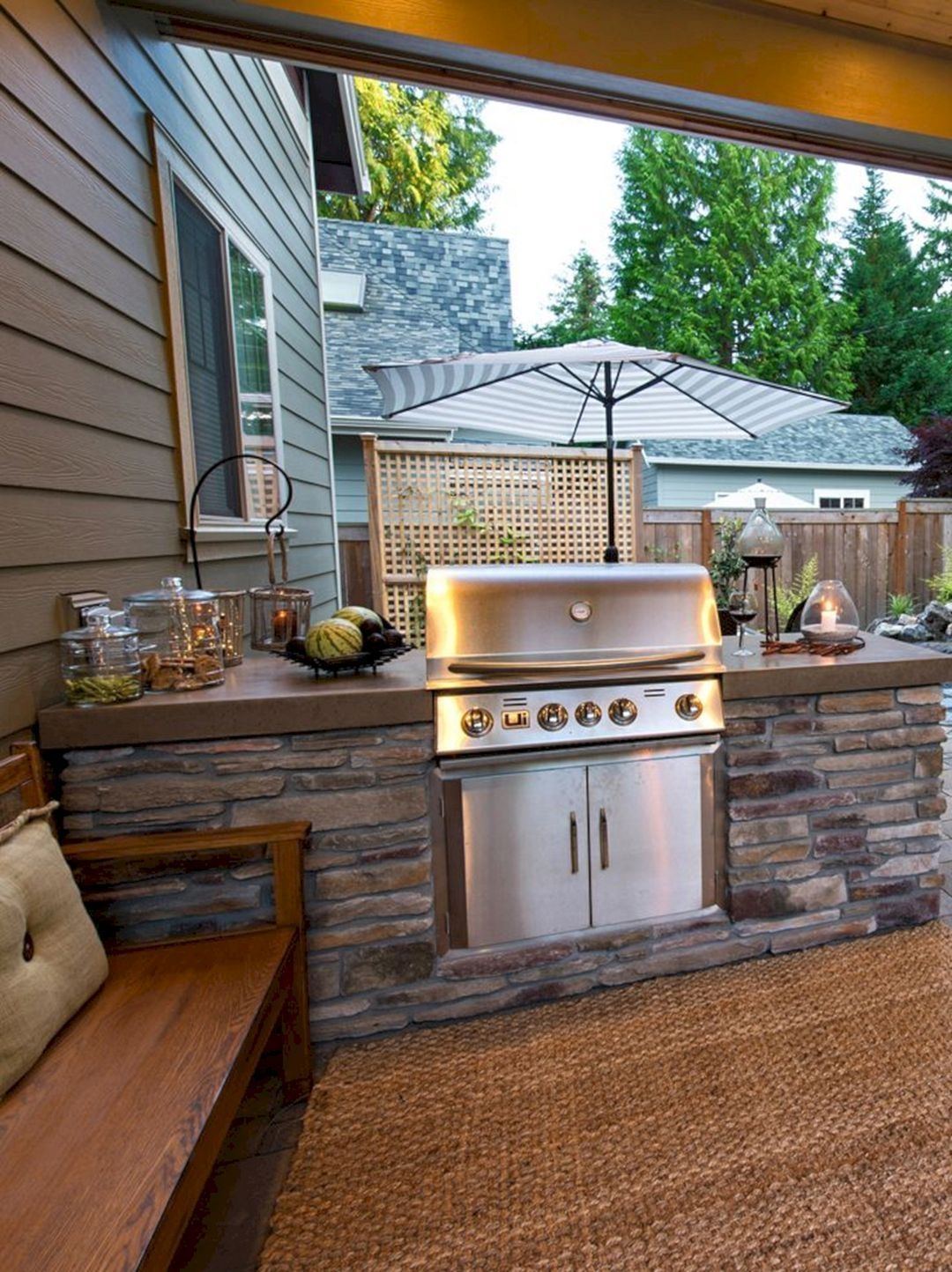 stone farmhouse sink wooden cabinet doors This backyard patio kitchen