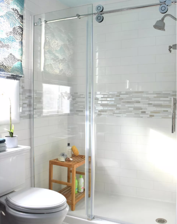 The deluxe bathroom has a deep soaking tub and vertically positioned subway  tiles