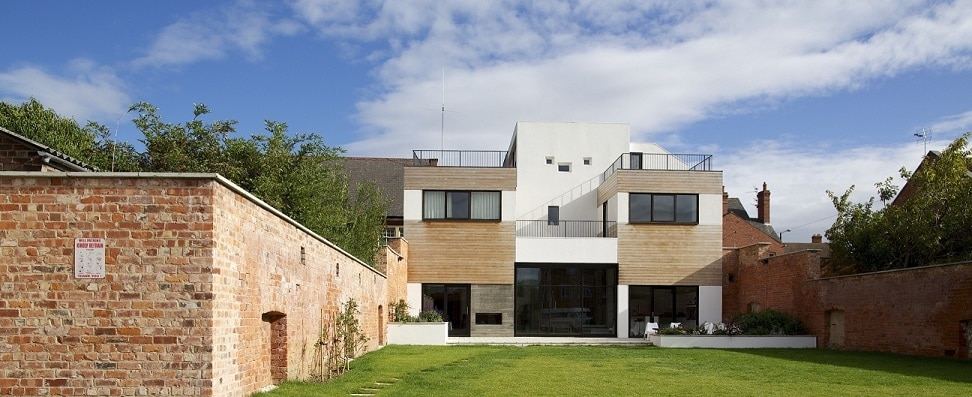 Modern back façade of render and timber, with small  'projector' window