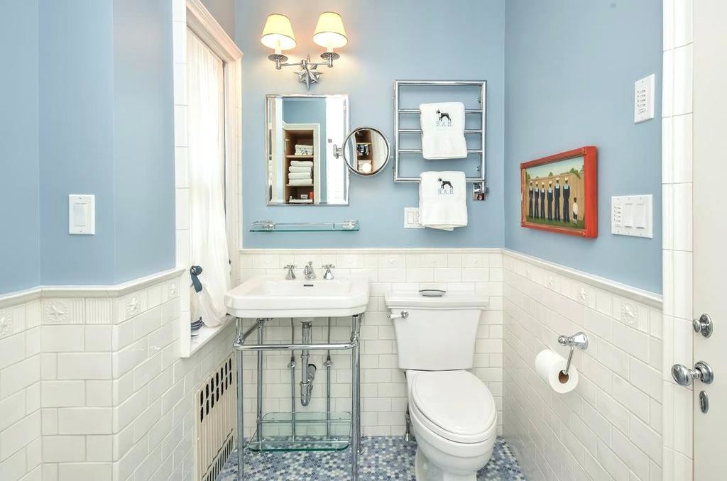 If you want to add blue to your bathroom without darkening your space,  choose a paler shade of blue and coordinate it with a combination of crisp  white,