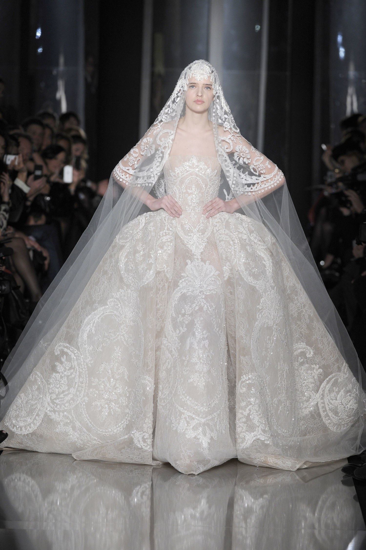 A woman tries on a wedding dress at a bridal fashion trade show