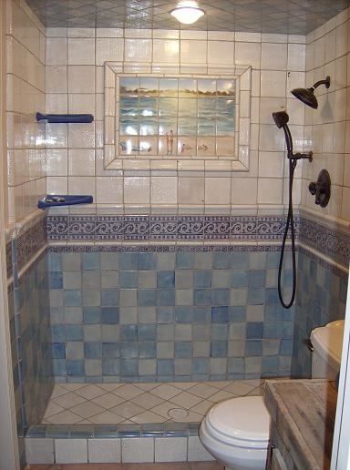 Gorgeous walk in shower boasts Saltillo Imports Large Sunflower Carrara  Thassos Tiles accenting white subway tiled wall complementing a white tiled  shower