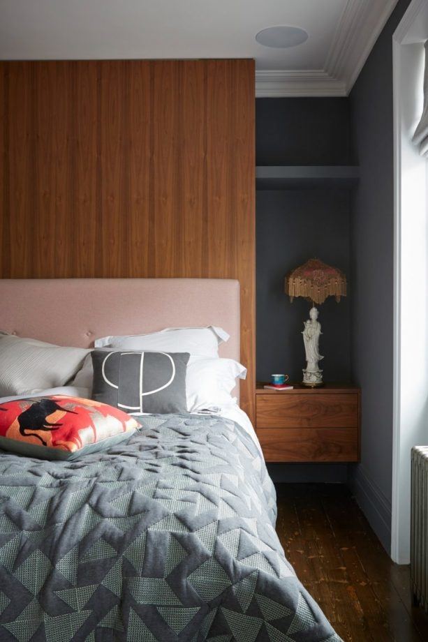 Dark wood and walls in masculine bedroom