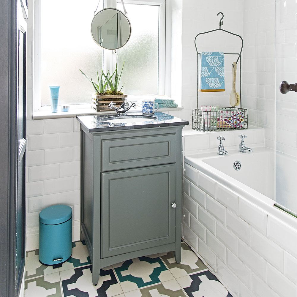 Bathroom with gold fixtures and blue tile floor